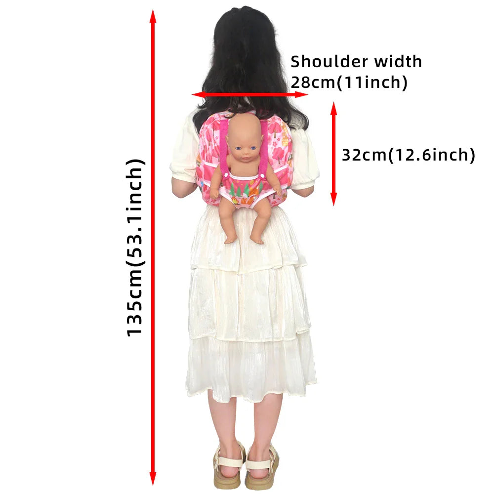 Child wearing a doll carrier backpack with a baby doll inside, showing product dimensions.