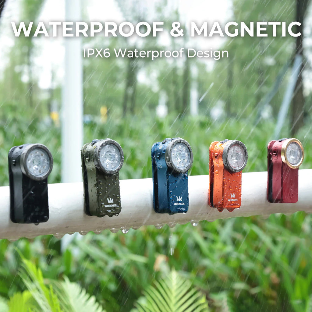 Colorful mini clip-on flashlights attached to a white bar in the rain demonstrating magnetic waterproof design.
