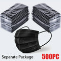 A stack of individually wrapped black 3-layer disposable face masks