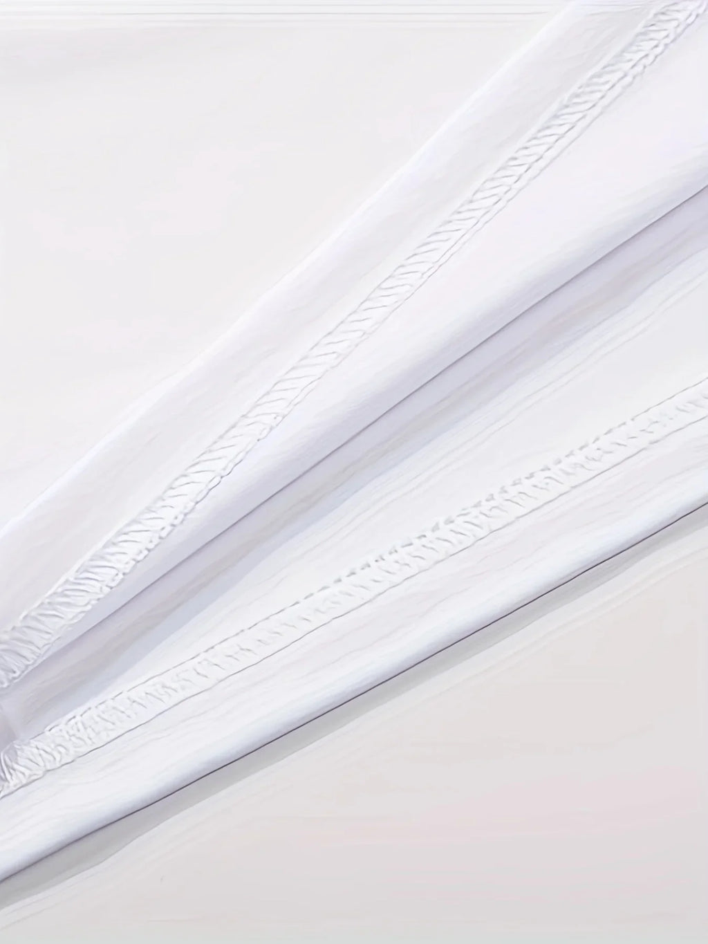 Close up detail of white fabric texture and stitching