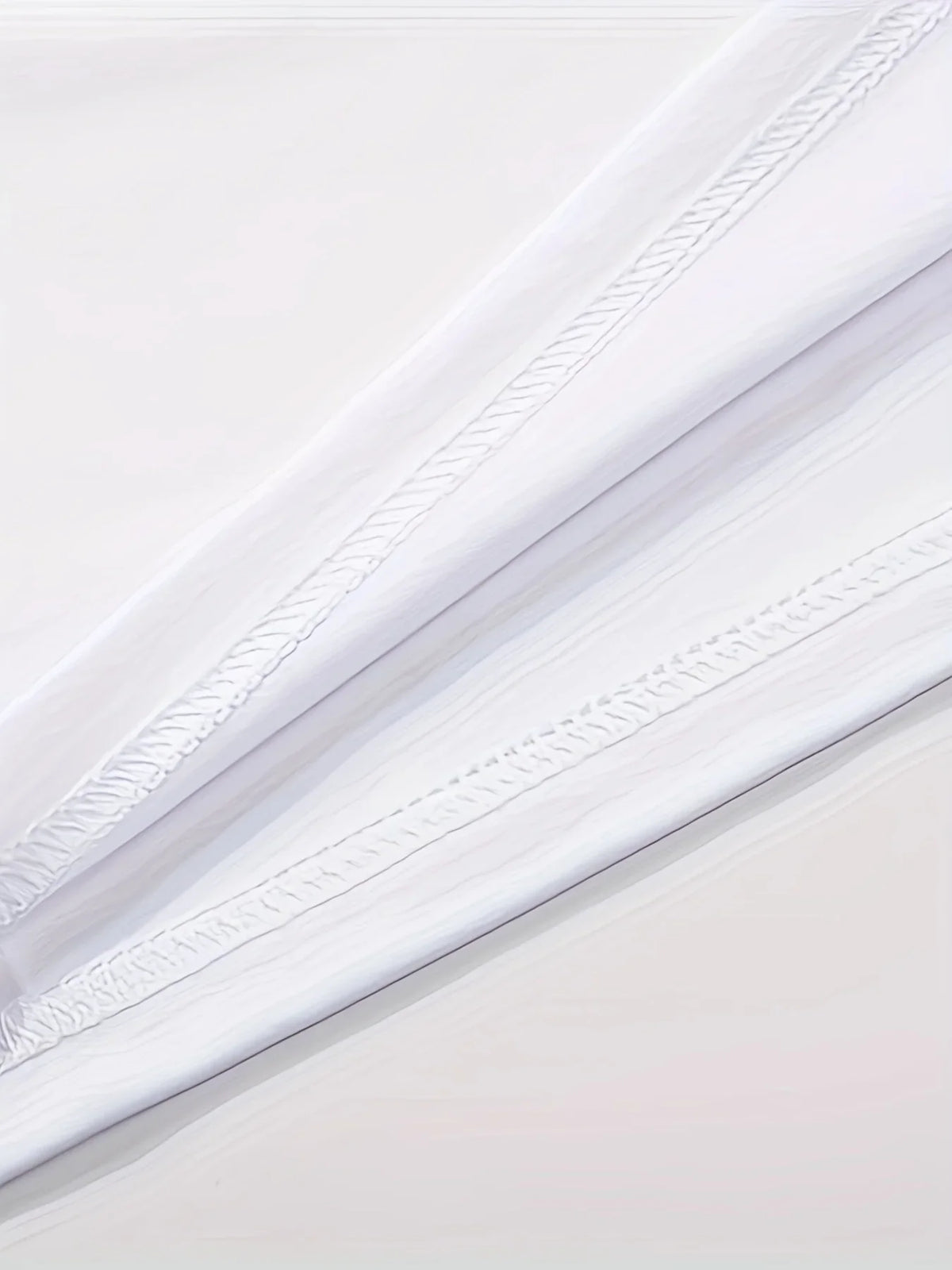 Close up detail of white fabric texture and stitching