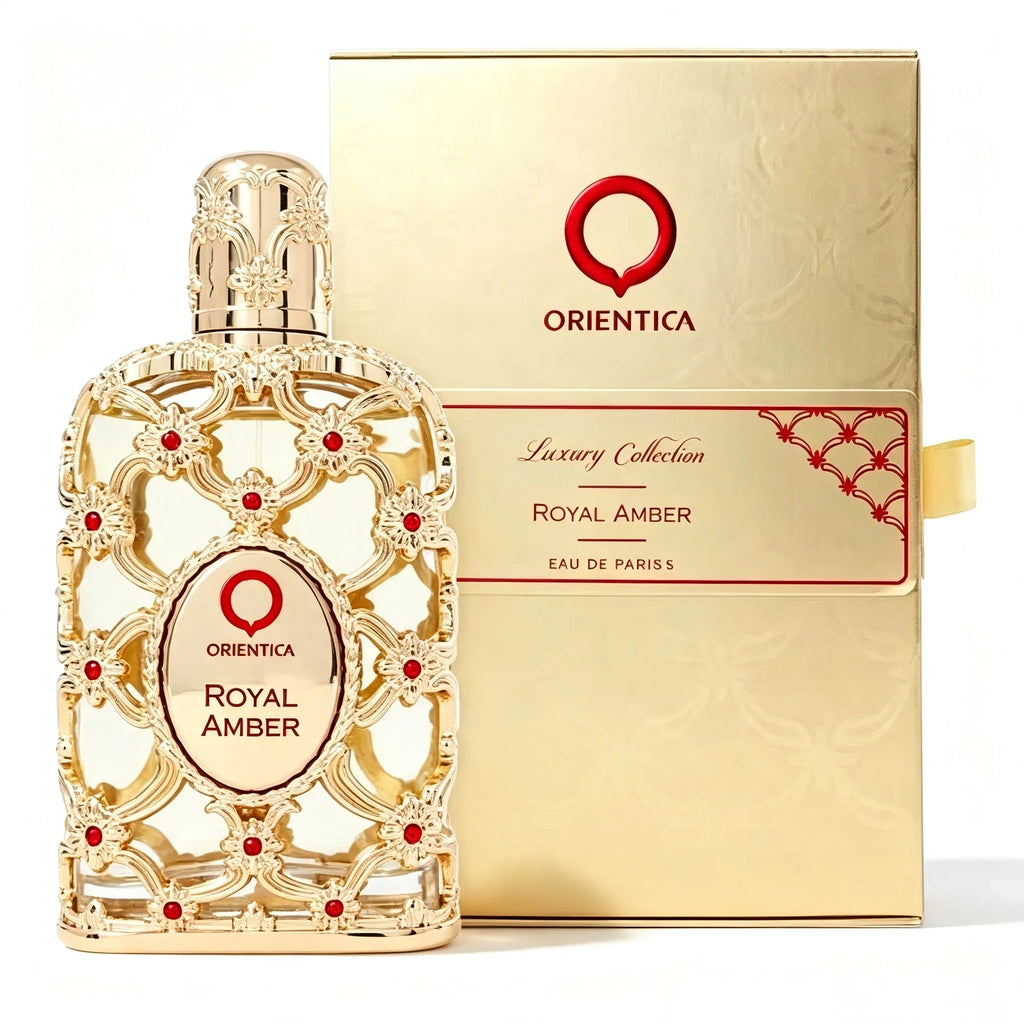 An ornate gold perfume bottle with red accents next to its matching gold retail box.