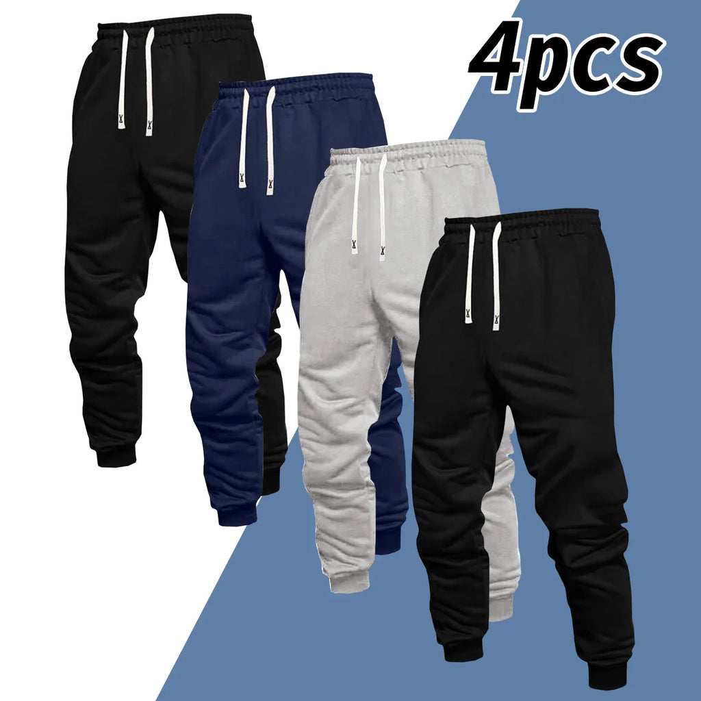 A set of four pairs of casual sweatpants in black, navy blue, and grey.