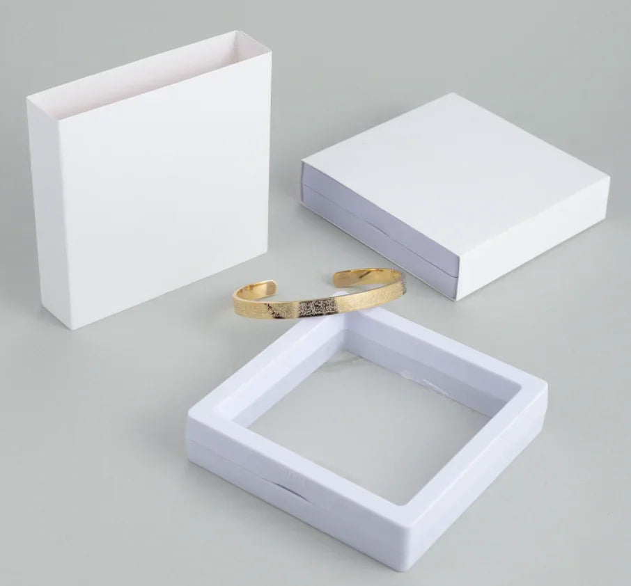Gold cuff bracelet in a jewelry display box with gift packaging