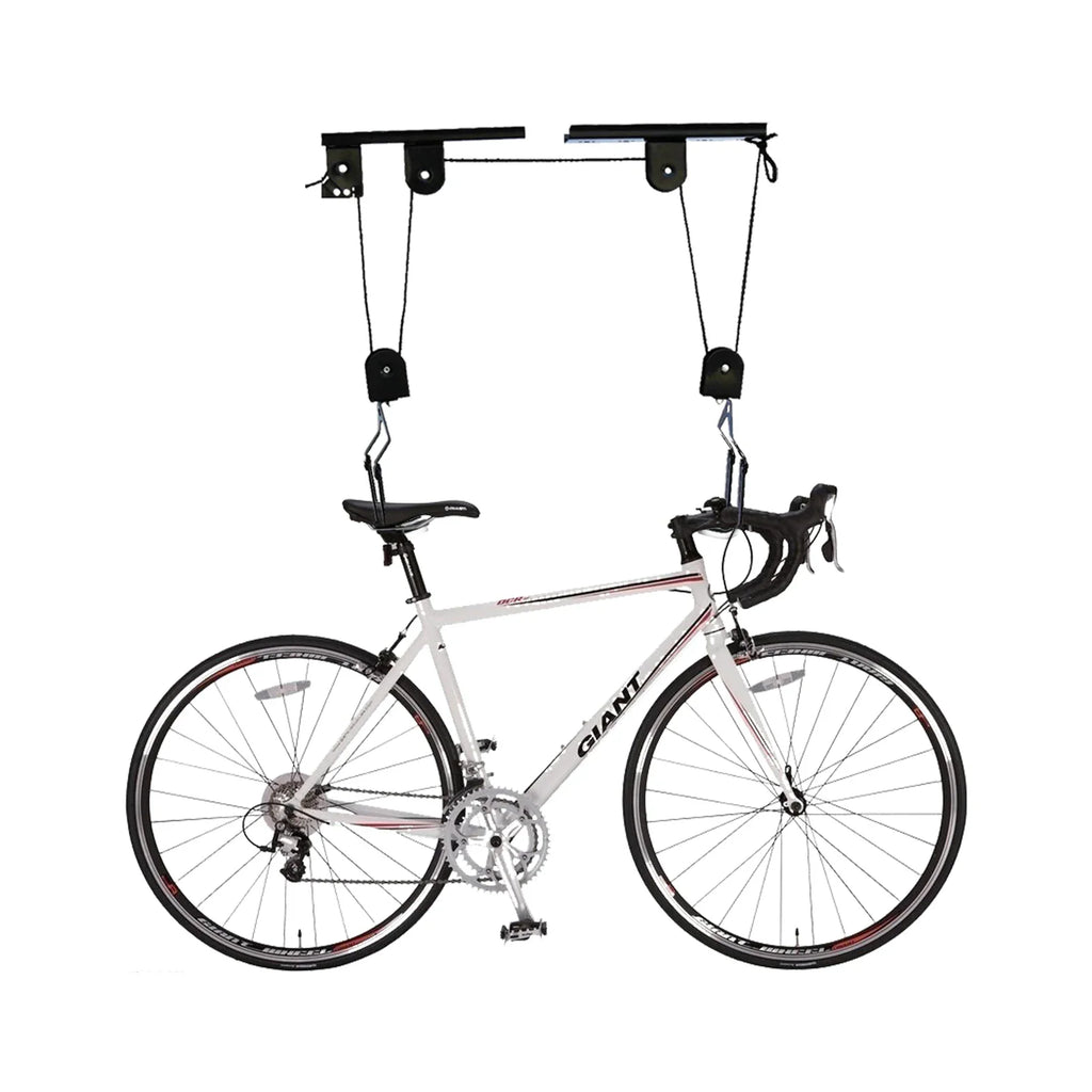 A white road bicycle suspended by a pulley ceiling hoist system on a white background.