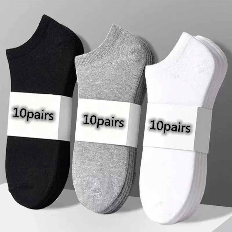 Three bundles of ten pairs of low-cut socks in black, grey, and white.
