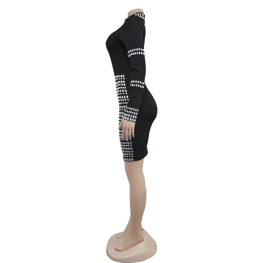 Side view of a black mini dress with long sleeves and silver rhinestone detailing on a mannequin.