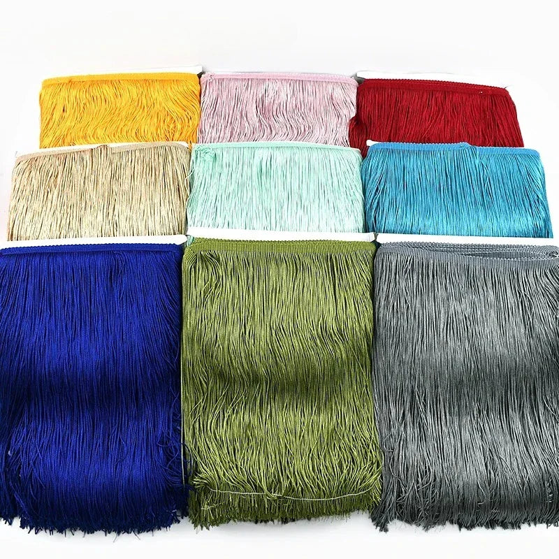 Nine colorful rolls of long tassel fringe trim arranged in a grid