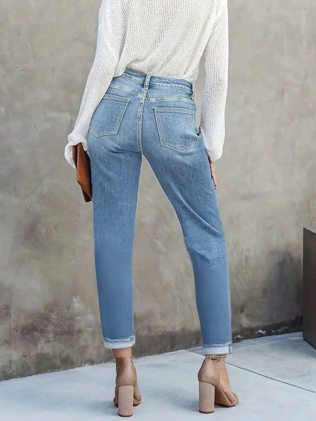 Rear view of high-waisted light blue skinny jeans with back pockets