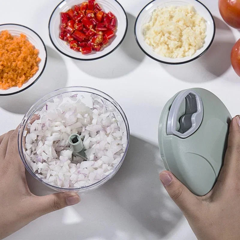 A person holding a manual hand-pulled vegetable chopper with chopped onions inside.