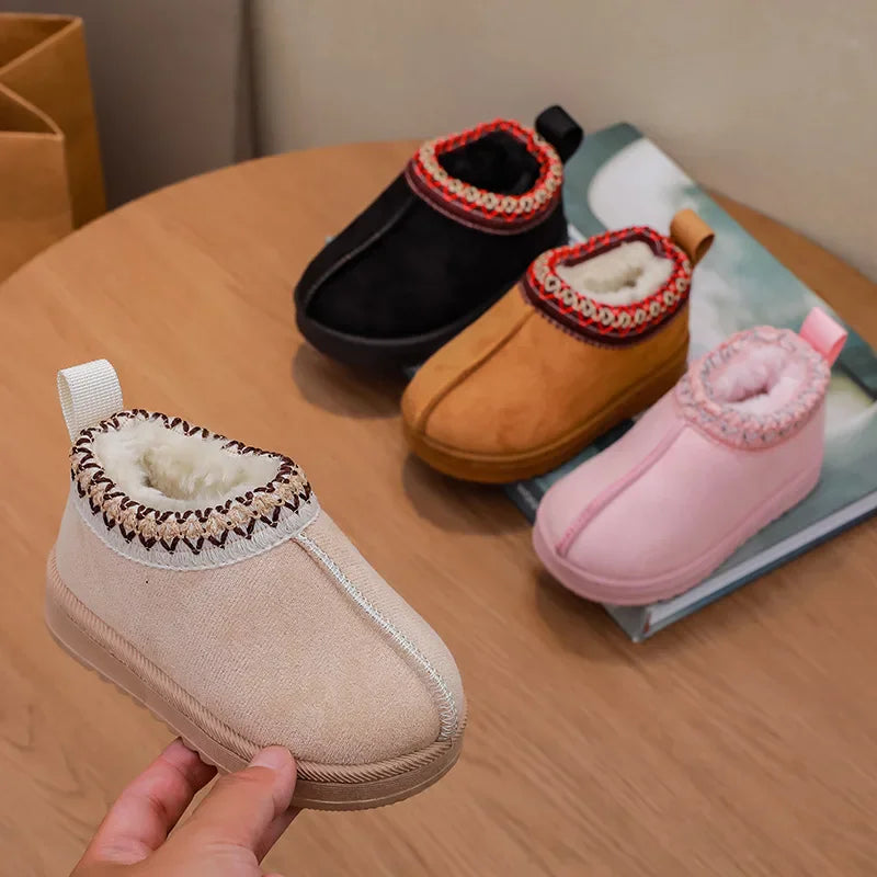 Four pairs of children's ankle boots in black, brown, beige, and pink with fur lining and embroidered collars