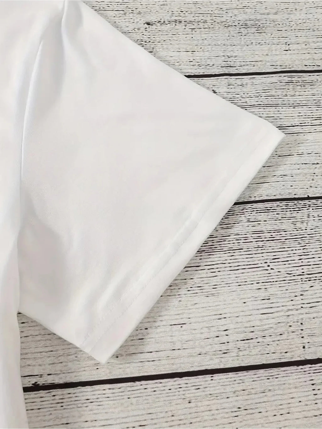 Close up view of t-shirt sleeve on wooden background