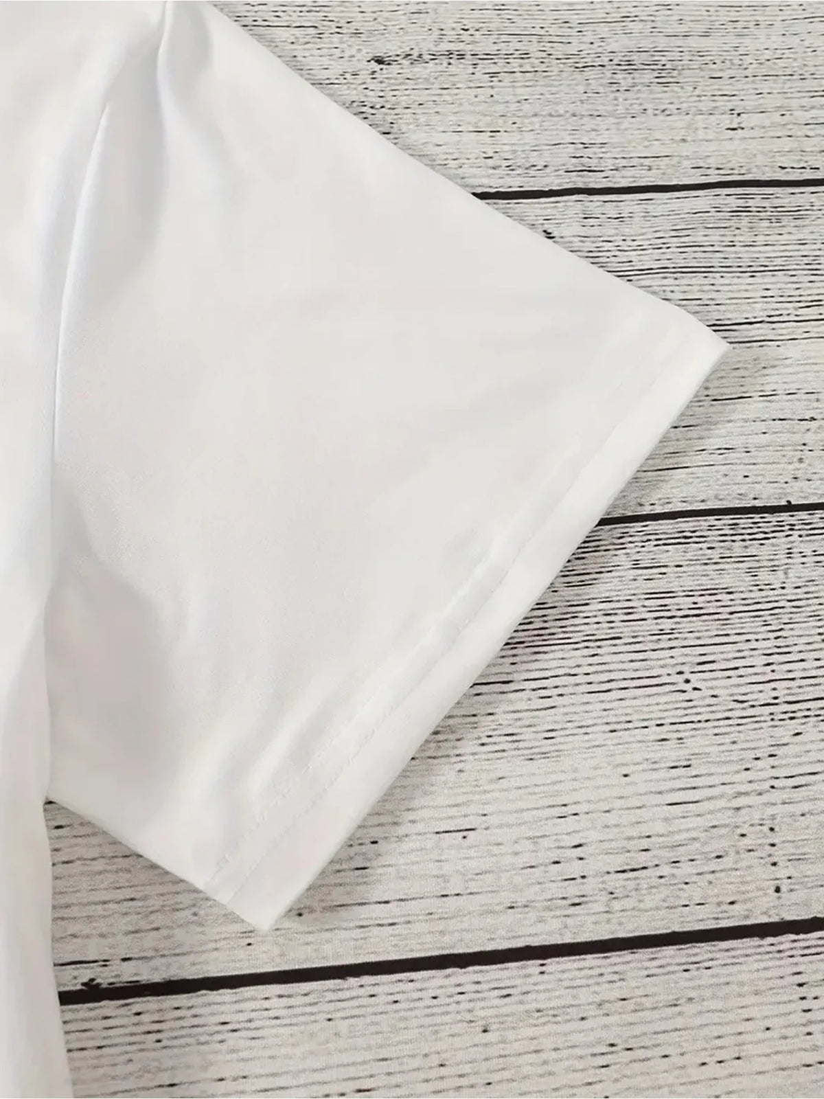 Close up view of t-shirt sleeve on wooden background