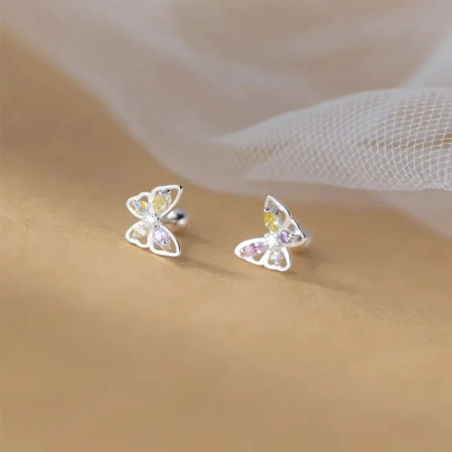 A pair of delicate silver butterfly earrings with small colorful crystals