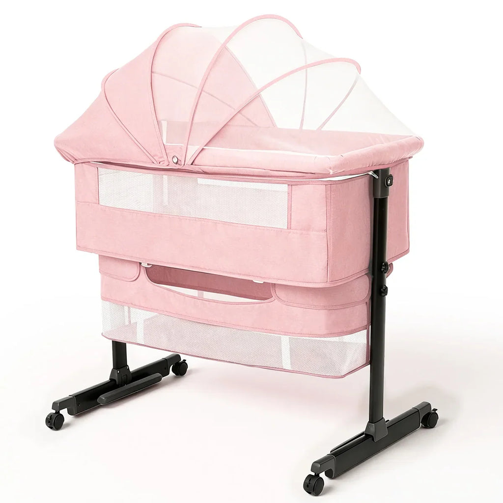 Pink portable baby bedside bassinet with mosquito net canopy and storage rack on wheels