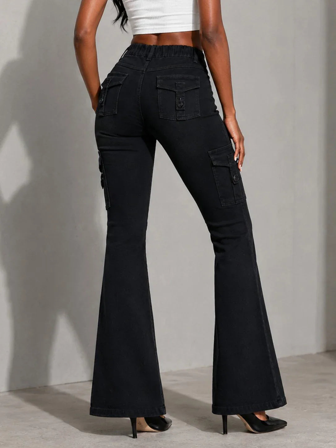 Black cargo flare jeans, back view, worn by a model.