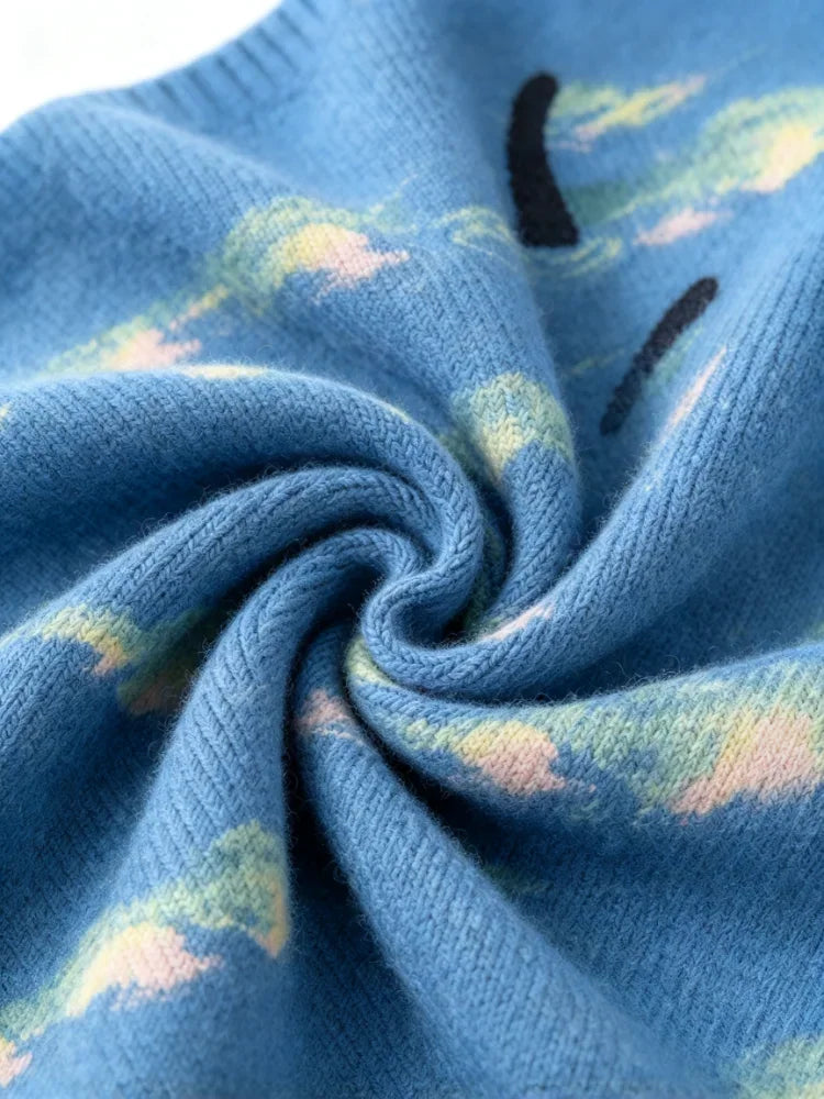 Close-up view showing the soft texture and knit pattern of the blue cat-themed sweater