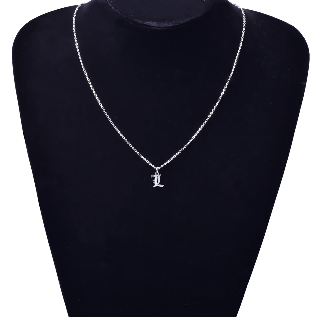 A silver letter initial pendant necklace displayed on a mannequin neck