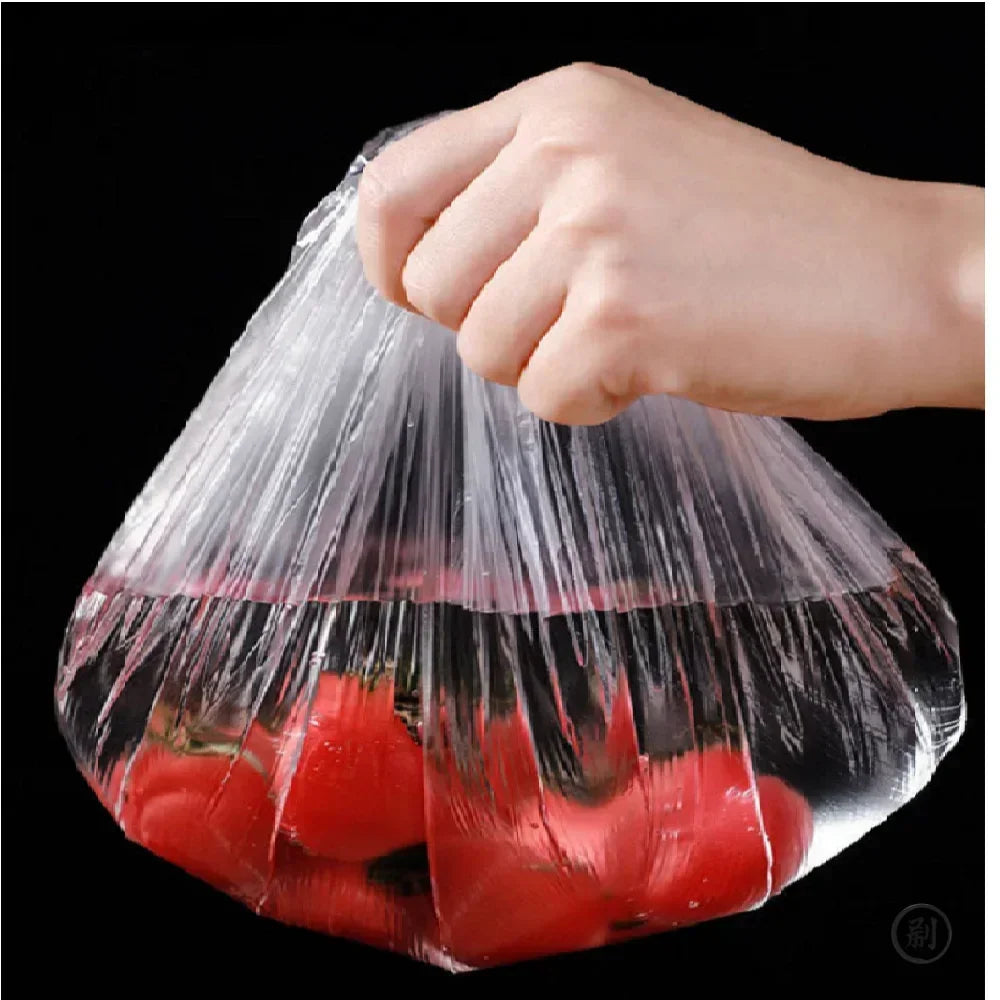 Elastic food cover wrapping a bowl of fresh tomatoes held by a hand