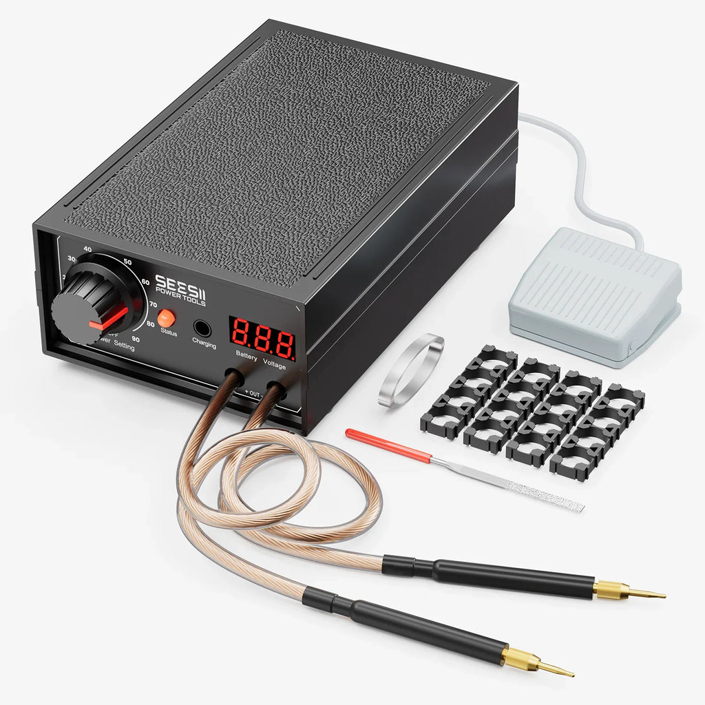 A portable spot welder device with welding pens, foot pedal, battery holders, and accessories.