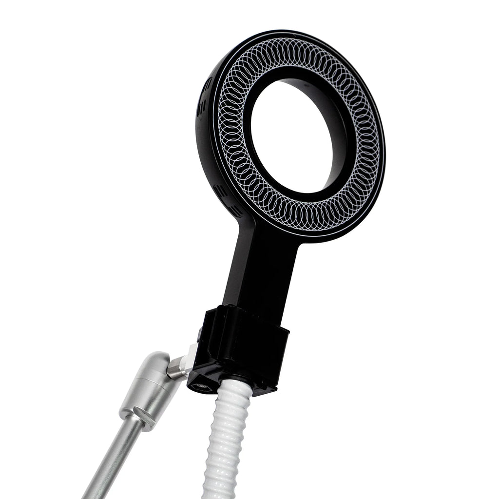 A close-up of a black circular magnetic ring applicator used for physical therapy treatment