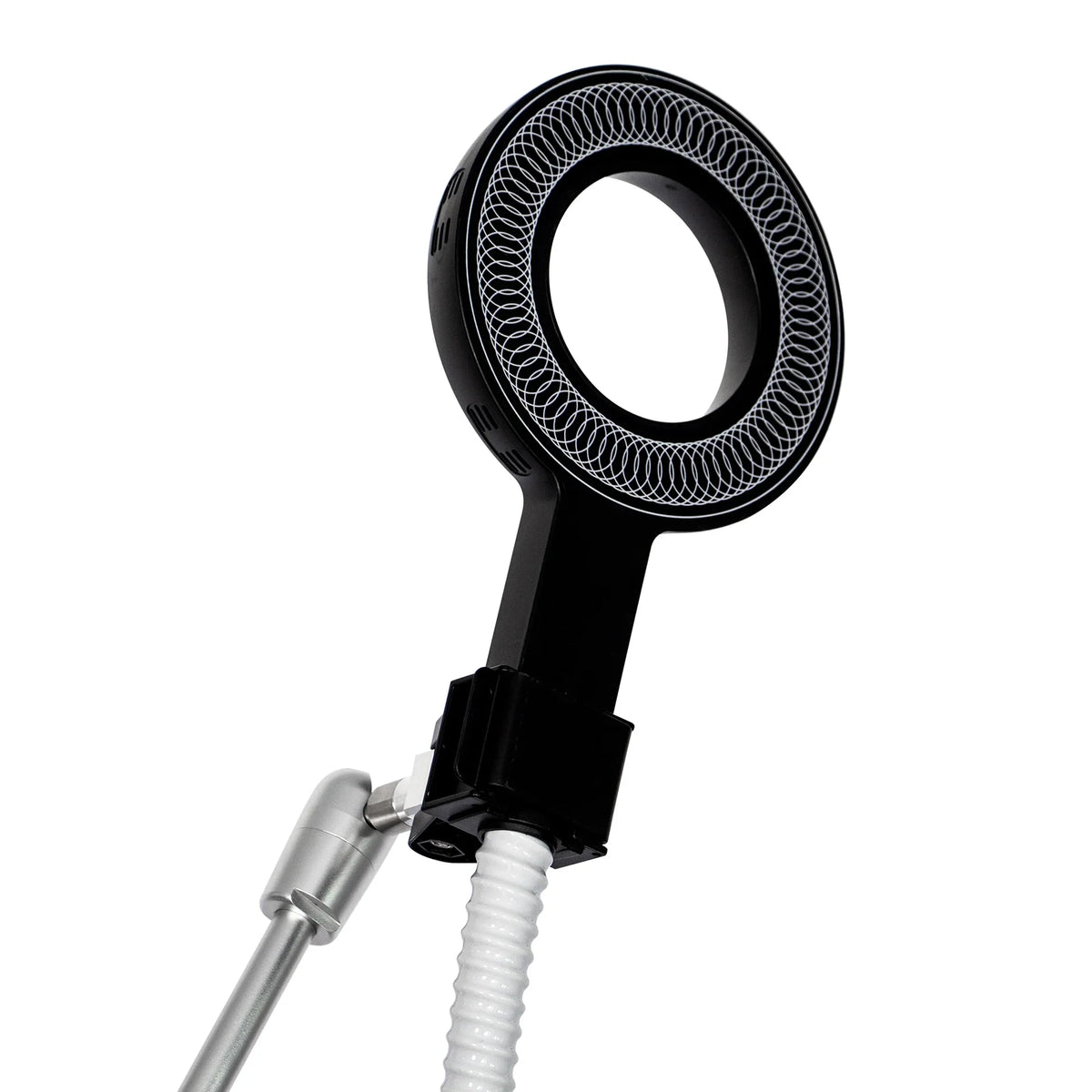 A close-up of a black circular magnetic ring applicator used for physical therapy treatment