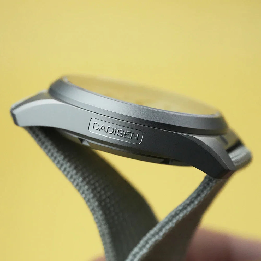 Close-up of a titanium chronograph watch case side showing branding