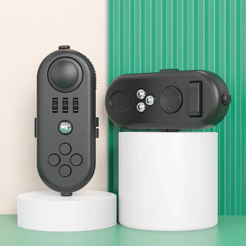 Black handheld fidget controller toy with buttons, rollers, and gears on display pedestals