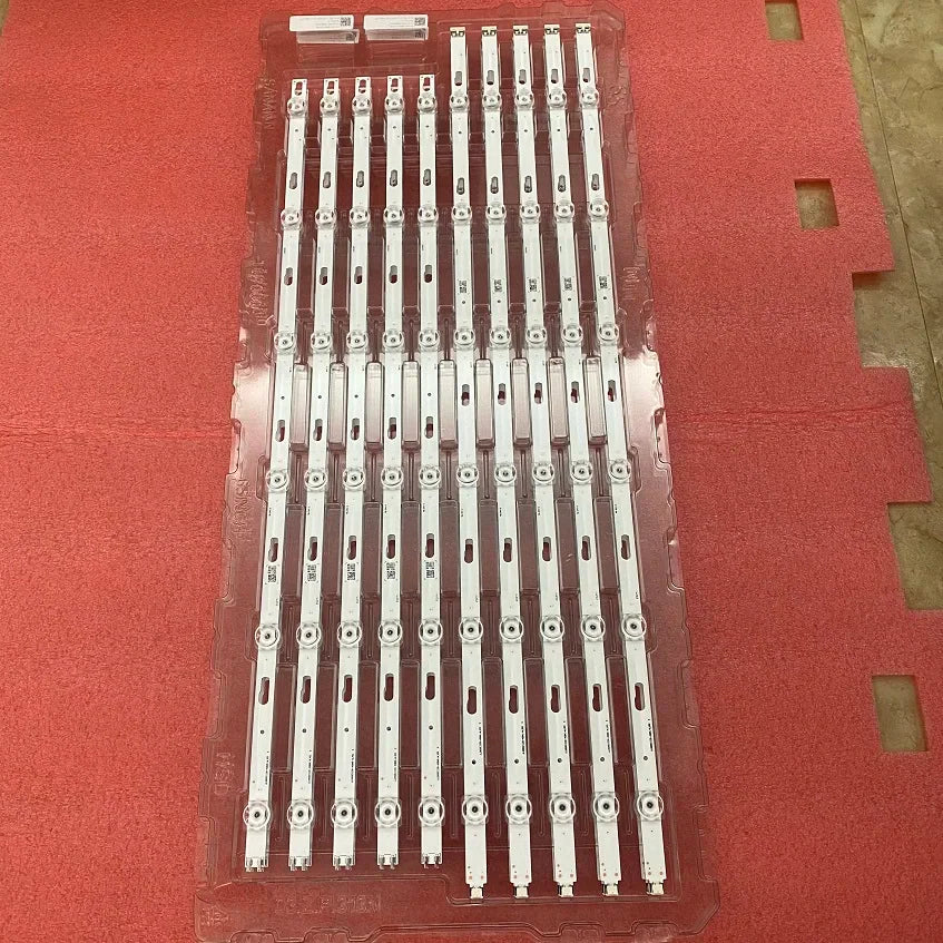 Rows of LED backlight strips for a television, arranged in clear plastic protective packaging.