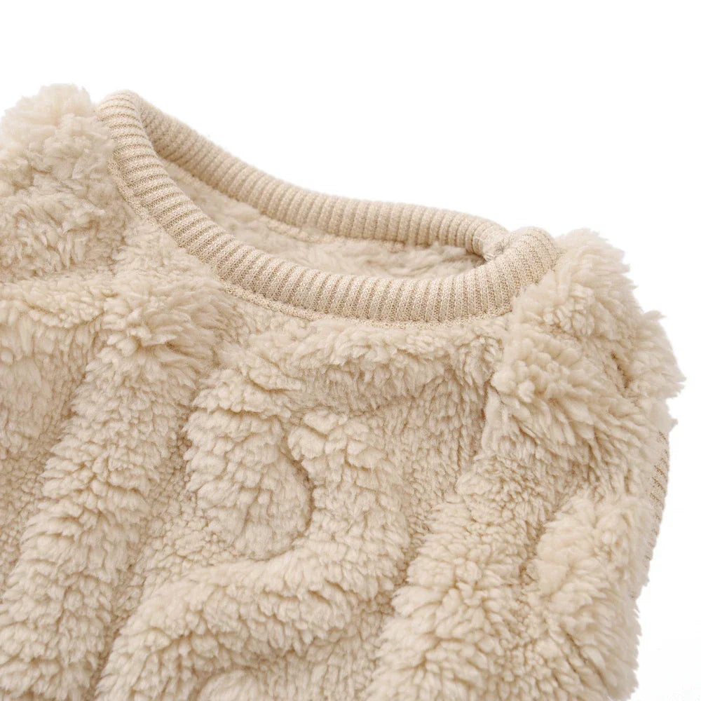 Close-up of a beige textured fleece dog sweater collar.