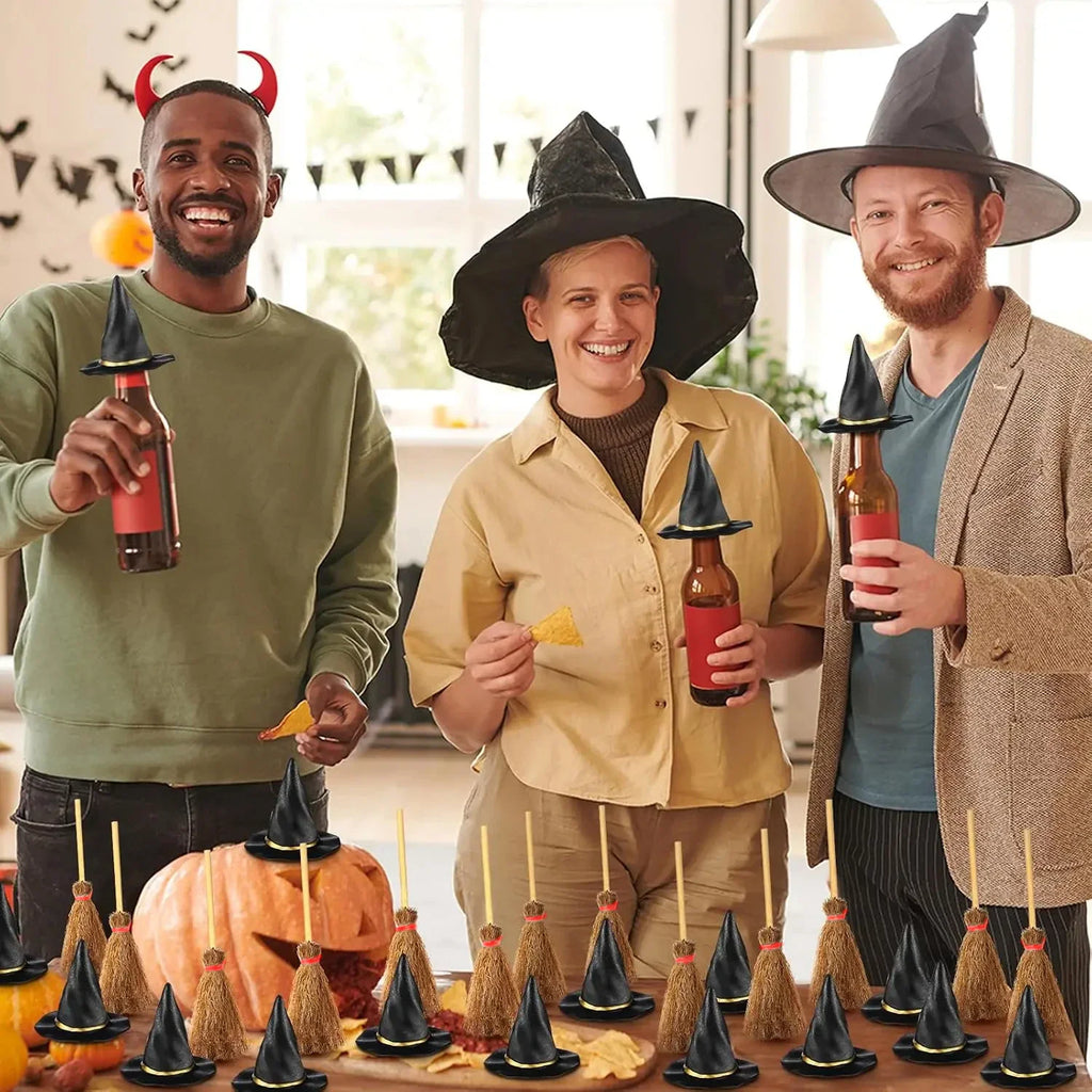 People wearing witch hats and holding miniature broomstick decorations at a Halloween party