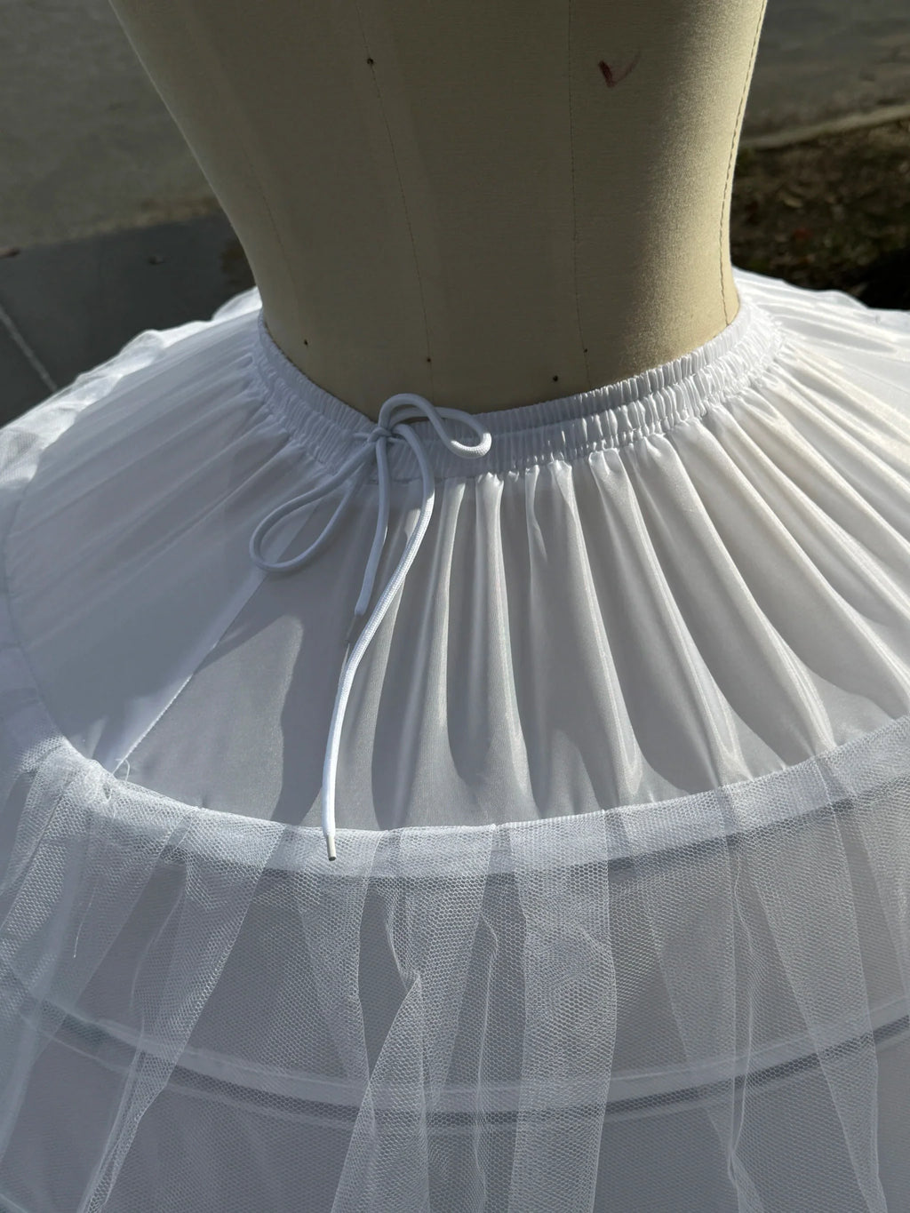 Close-up of white petticoat waist with adjustable drawstring