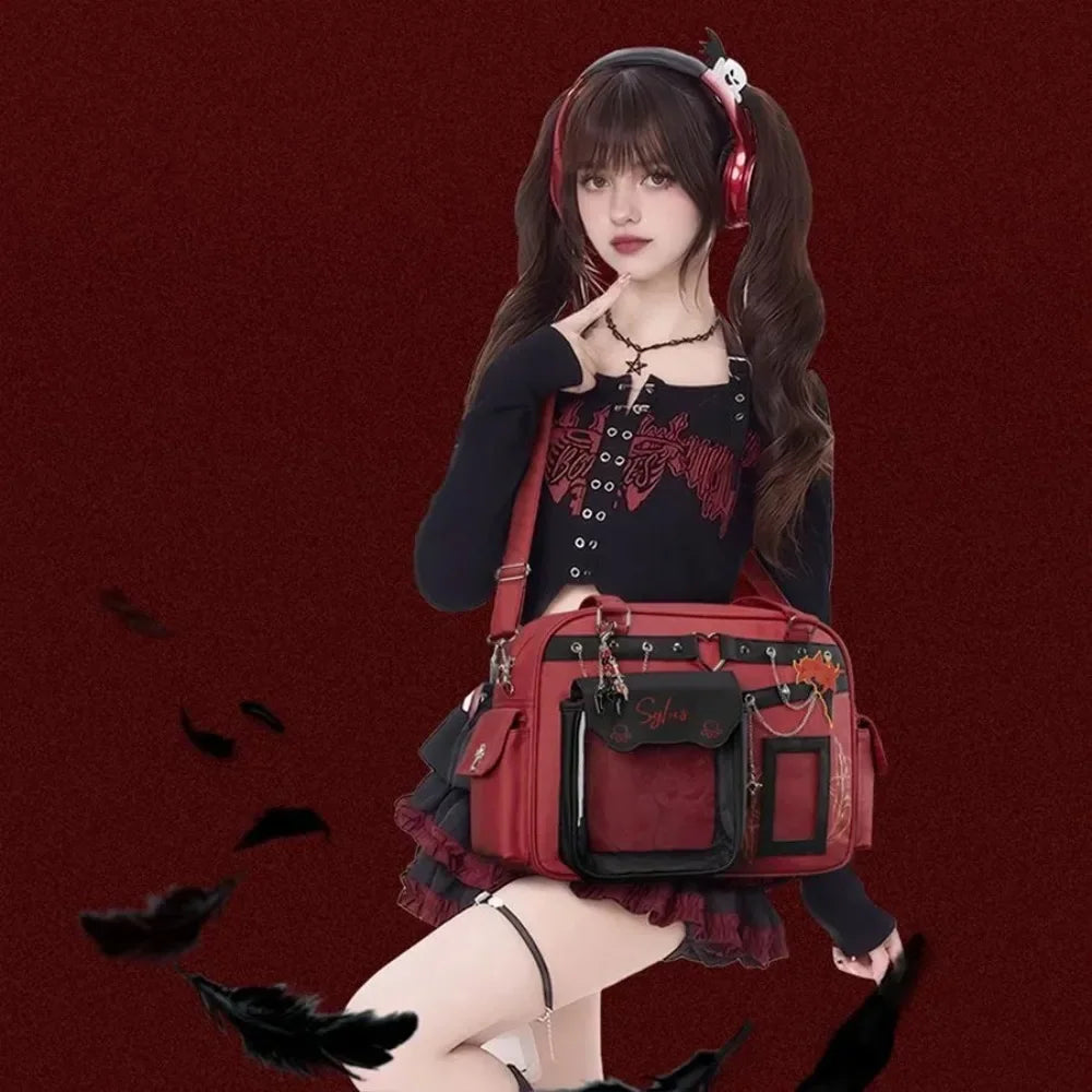 Model posing with a red and black gothic crossbody ita bag.