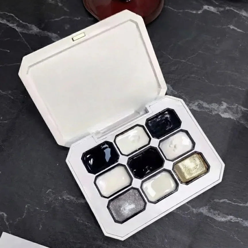 A nine-color solid gel nail polish palette in a white rectangular case.
