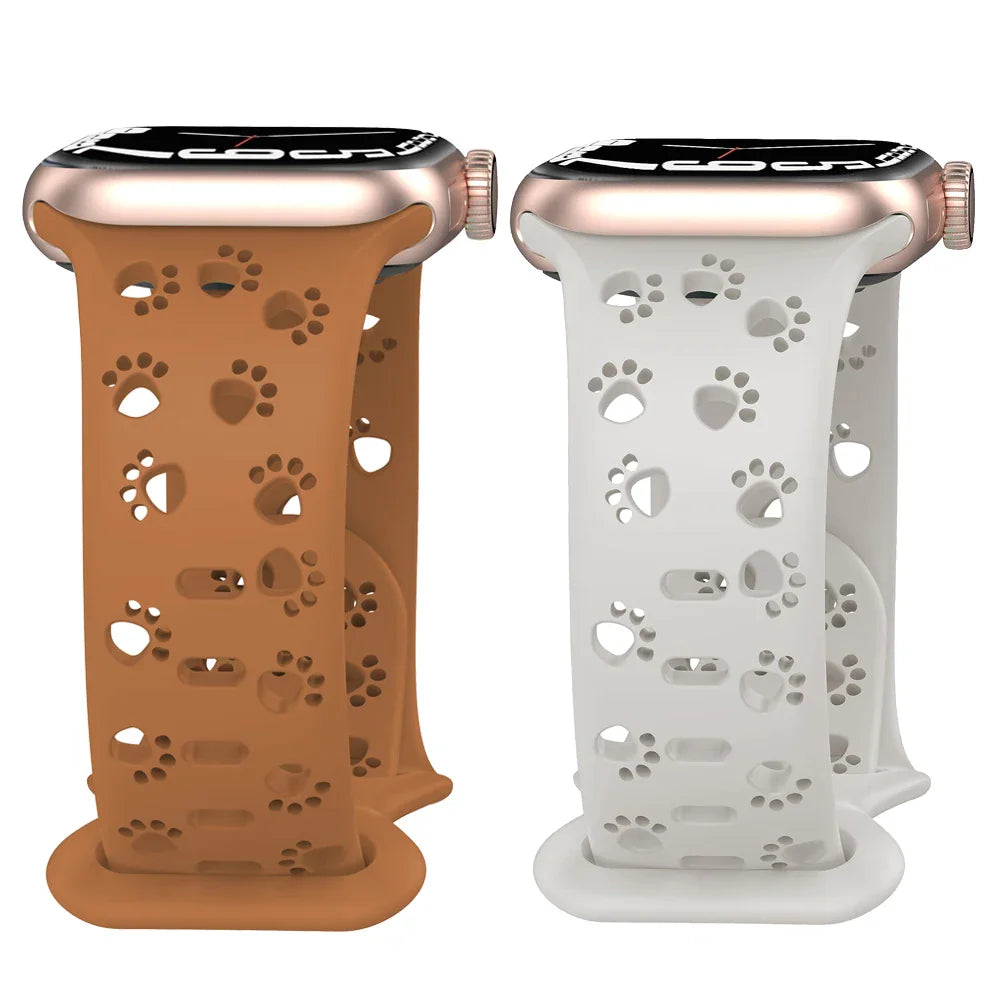 Brown and white silicone watch bands with paw print cutouts on watches