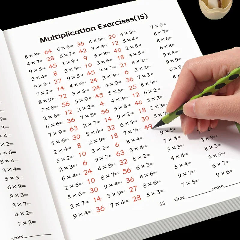 A hand using a green pen to complete multiplication exercises in a workbook.
