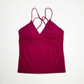 A sleeveless deep-v workout tank top in magenta with thin straps.
