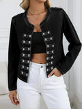 Woman wearing a black washed denim jacket with double-row button detailing and white jeans