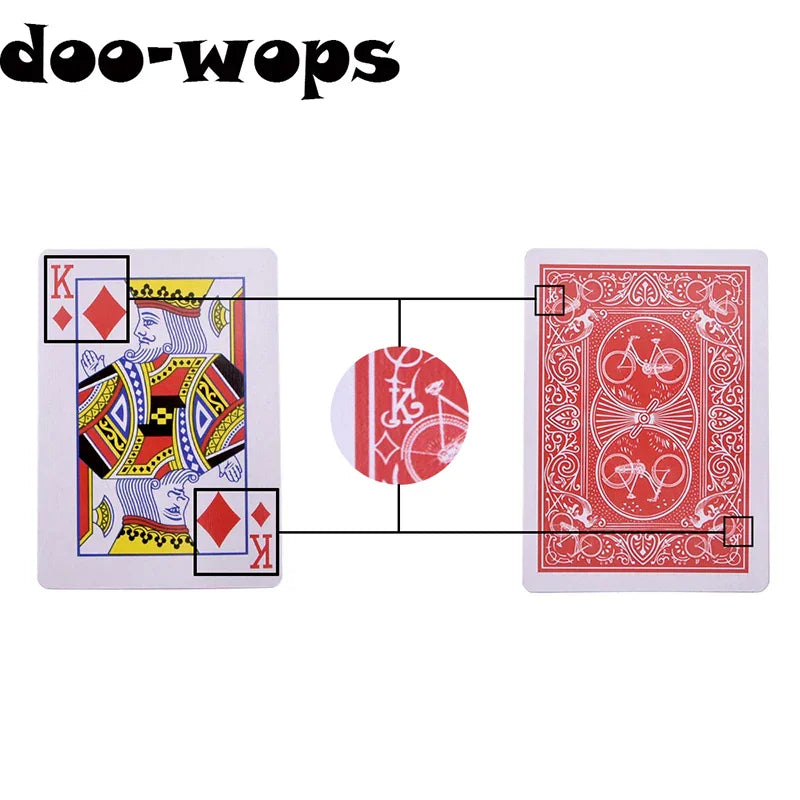 King of diamonds playing card and the back of a bicycle playing card with markings highlighted.