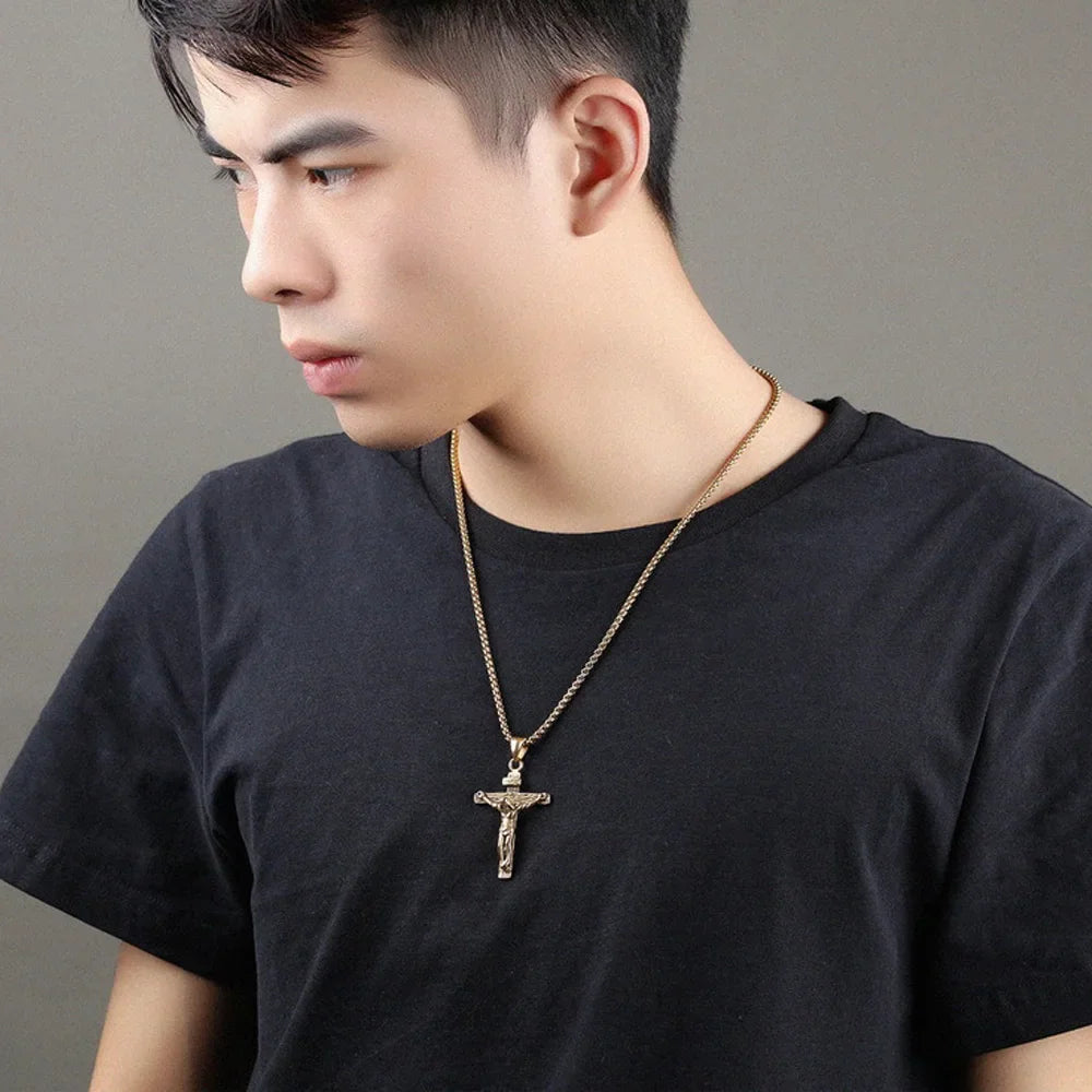 Man wearing a gold crucifix pendant necklace with chain