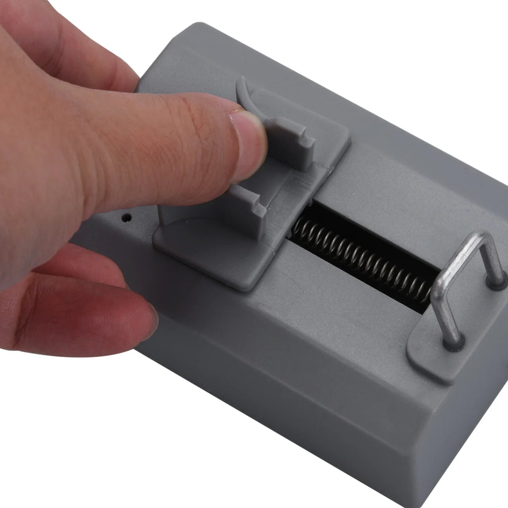 Hand adjusting the slider on a grey watch timegrapher test device