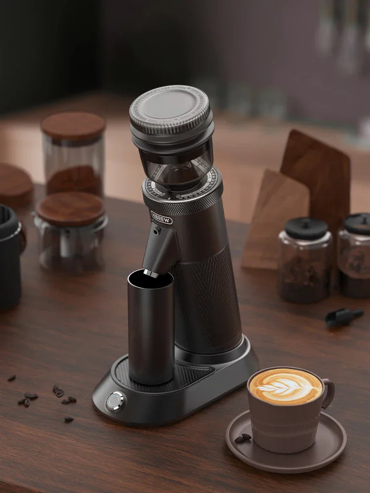 Electric coffee grinder on a wooden table with a cup of espresso
