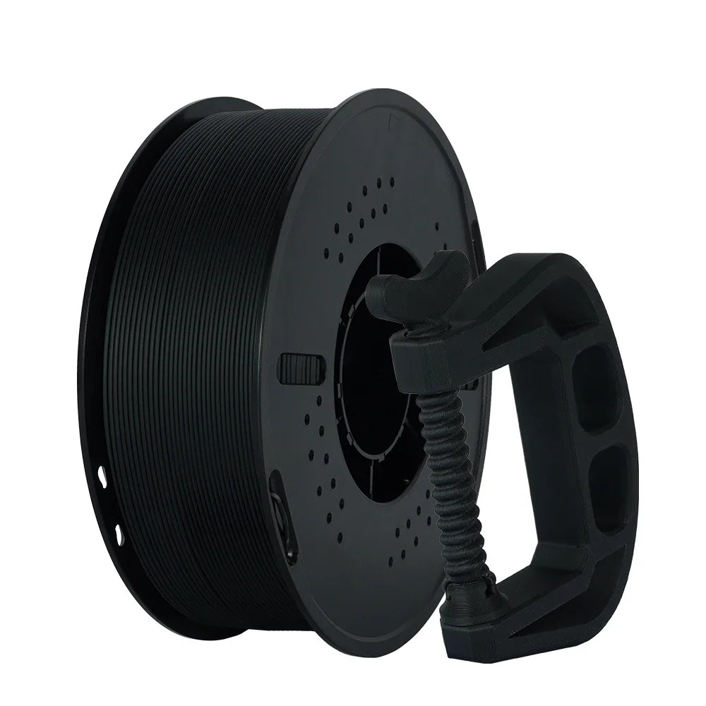 A spool of black 3D printer filament standing next to a 3D printed clamp tool.