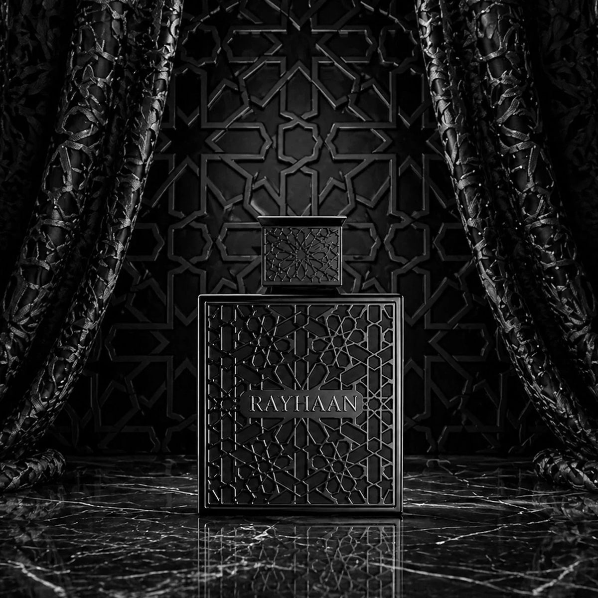 Black fragrance bottle with intricate pattern displayed in front of elegant dark draped curtains