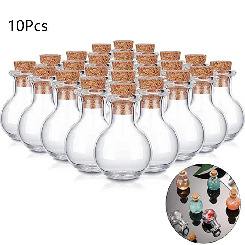 Ten small transparent round glass bottles with cork stoppers arranged in a group