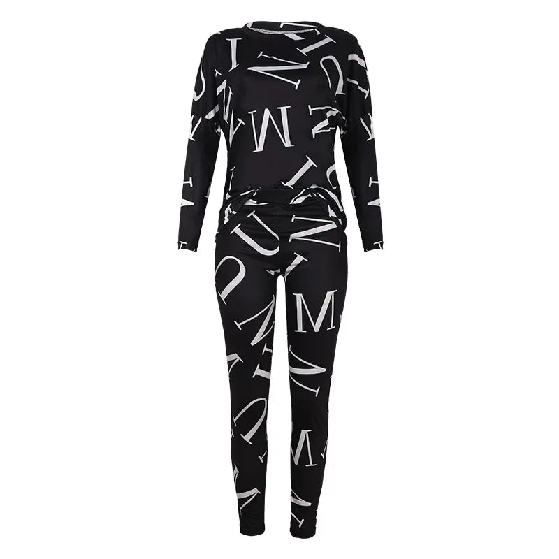 Women's black long sleeve top and pants tracksuit with white letter print on a plain background