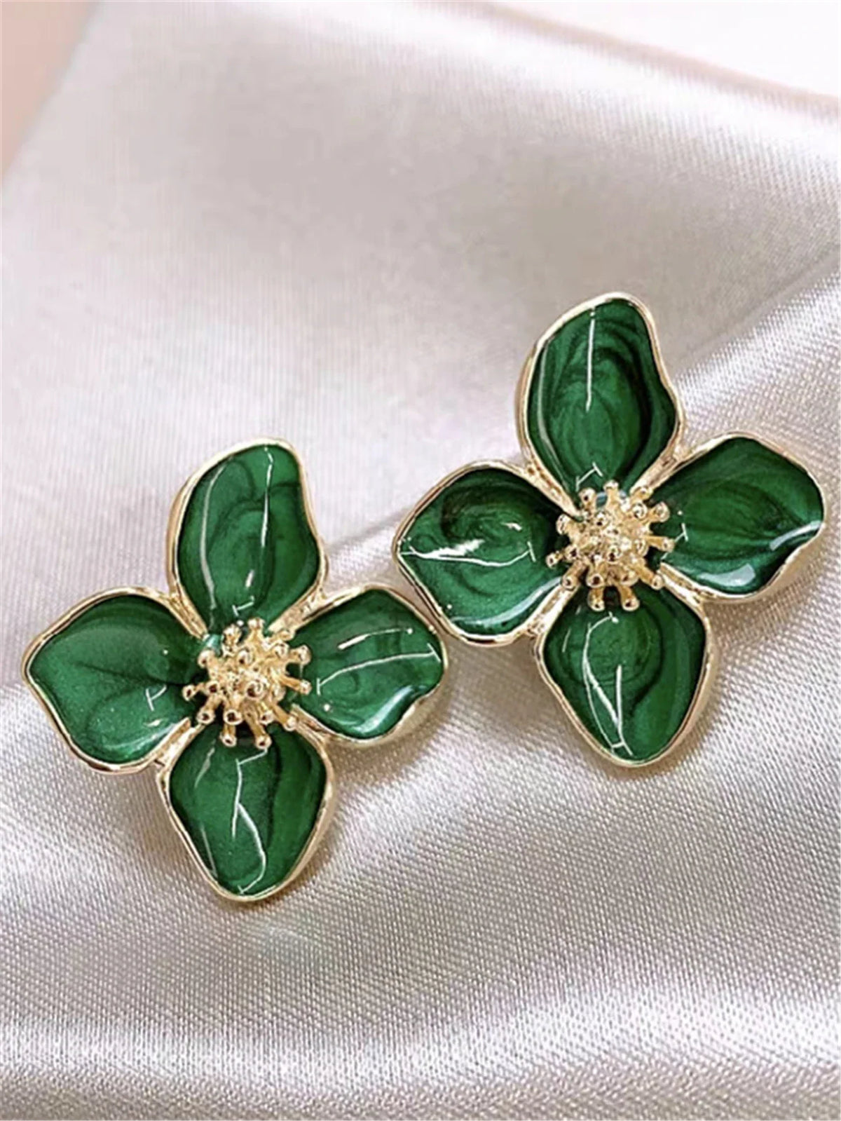 Green floral stud earrings with gold trim and textured petals