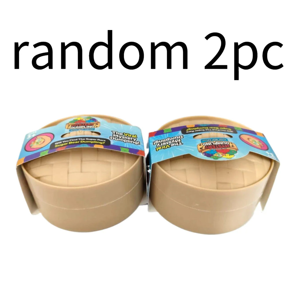 Two toy surprise dumpling boxes in bamboo-style containers