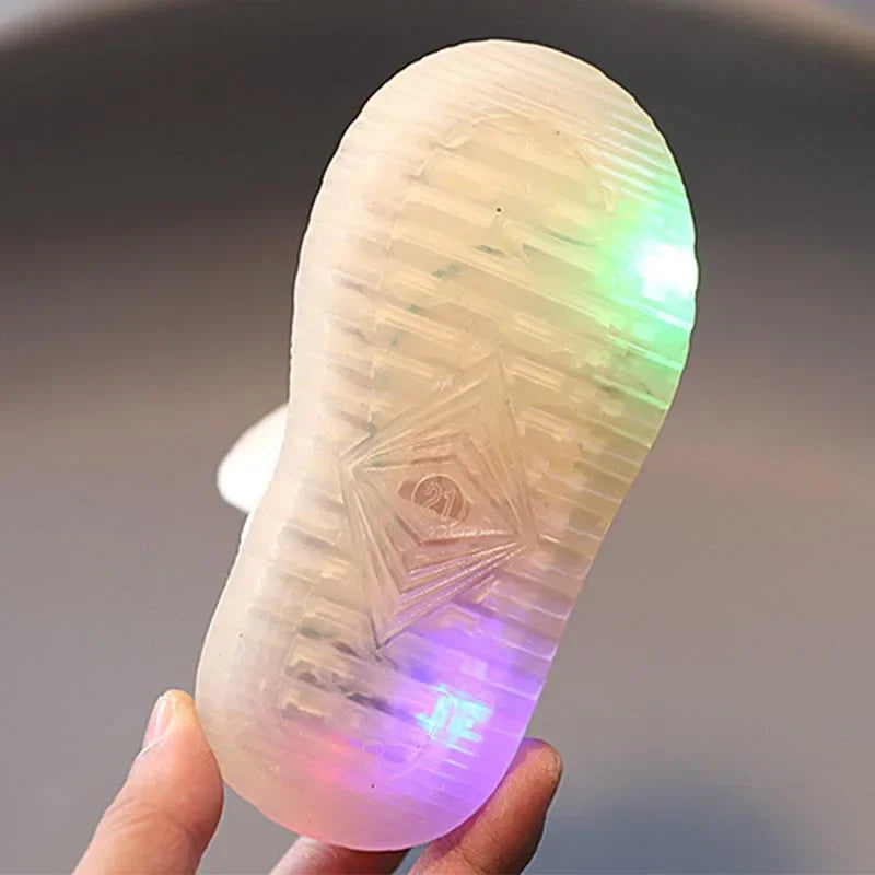 Translucent sole of a light-up toddler shoe showing the size number