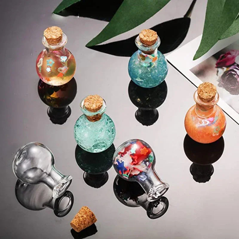 Small round glass bottles with cork stoppers containing colourful glitter and confetti